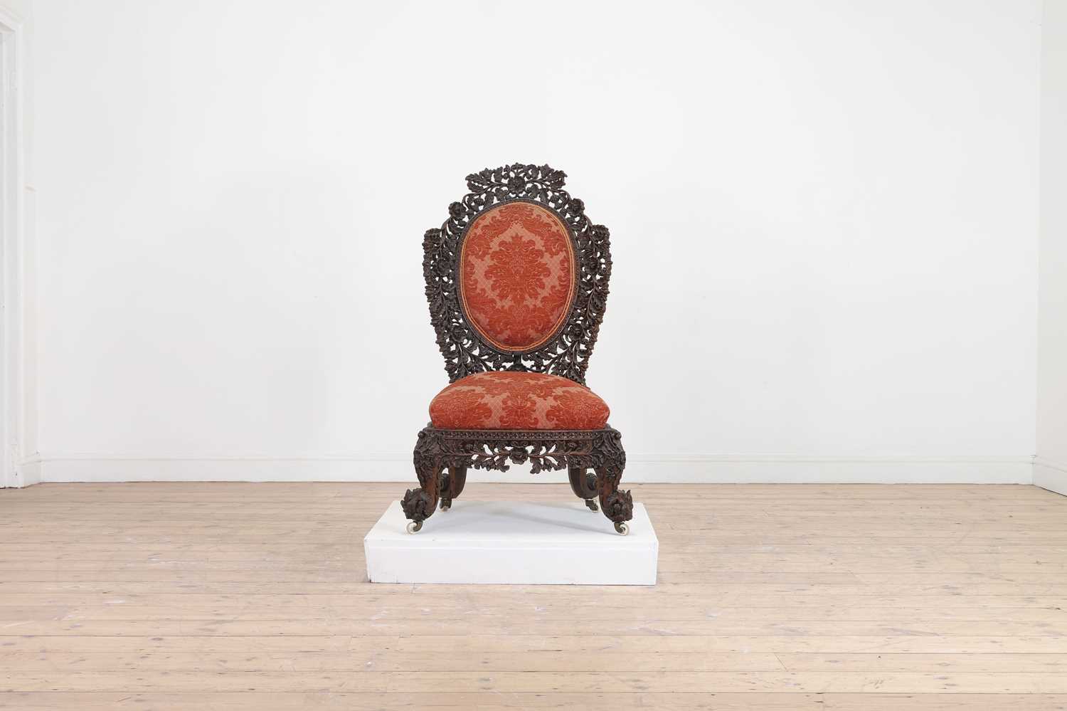 Lot 236 - A carved teak low chair