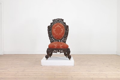 Lot 236 - A carved teak low chair