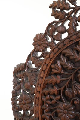 Lot 236 - A carved teak low chair