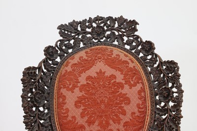 Lot 236 - A carved teak low chair