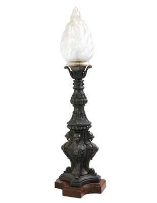 Lot 431 - A patinated metal floor lamp with flame shade