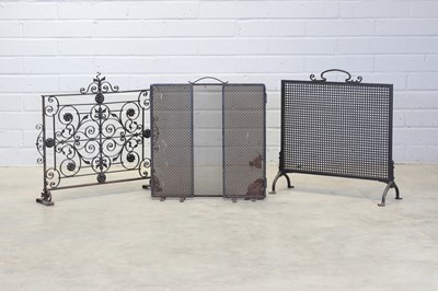 Lot 385 - Three wrought iron firescreens