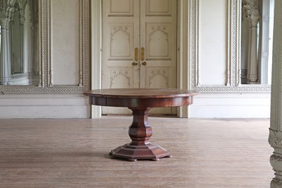 Lot 86 - A large circular walnut extending dining table