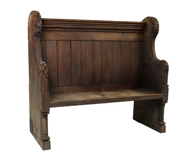 Lot 390 - A carved oak settle or pew