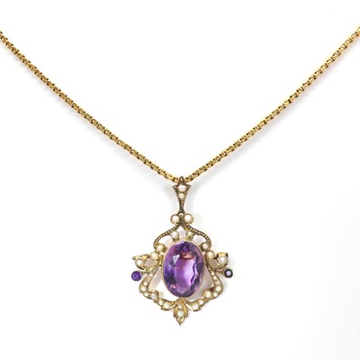 Lot 29 - An Edwardian amethyst and split pearl scrolling brooch/pendant