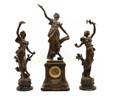 Lot 247 - A spelter clock garniture