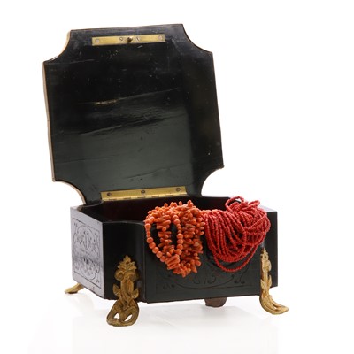 Lot 1325 - A wooden box containing a collection of coral jewellery