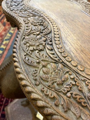 Lot 80 - A near pair of teak camel occasional tables