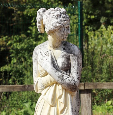 Lot 493 - A composite stone garden statue of a classical maiden