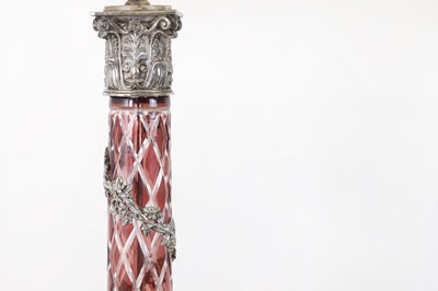 Lot 197 - A pair of red glass and metal-mounted column lamps