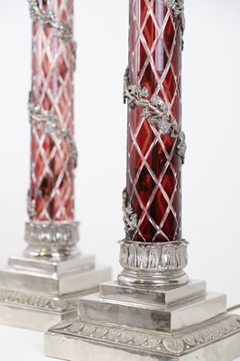 Lot 197 - A pair of red glass and metal-mounted column lamps