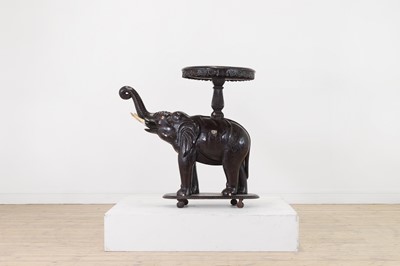 Lot 313 - A painted hardwood elephant occasional table