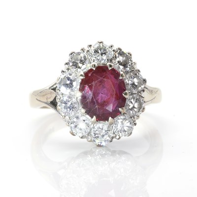 Lot 1136 - A white gold ruby and diamond oval cluster ring