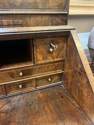 Lot 67 - A George I walnut bureau bookcase in the manner of Coxed & Woster