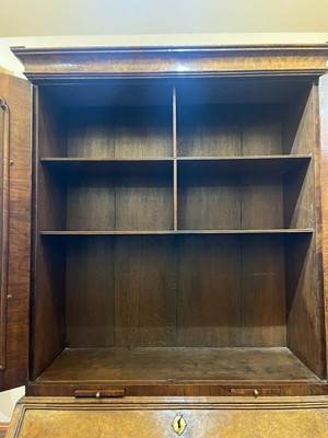 Lot 67 - A George I walnut bureau bookcase in the manner of Coxed & Woster