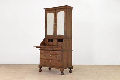 Lot 67 - A George I walnut bureau bookcase in the manner of Coxed & Woster