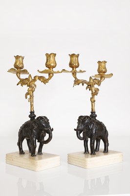 Lot 133 - A pair of gilt and patinated bronze candelabra