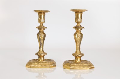 Lot 168 - A pair of Régence-style ormolu candlesticks