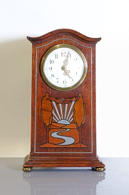 Lot 58 - An oak-inlaid and pewter-mounted mantel clock