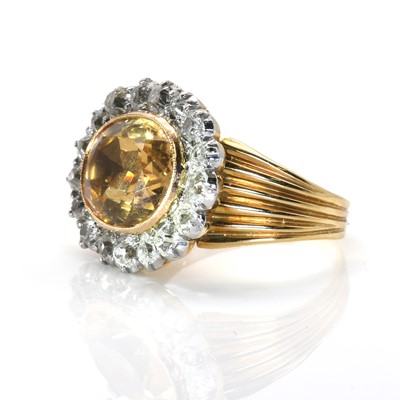 Lot 18 - A foiled topaz and diamond oval cluster ring