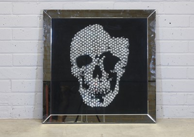 Lot 521 - A contemporary 'skull' wall mirror