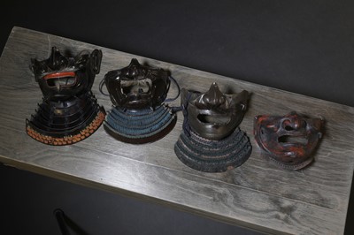 Lot 130 - A group of four Japanese menpo