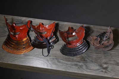 Lot 130 - A group of four Japanese menpo