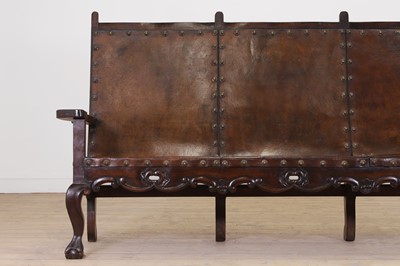 Lot 54 - A walnut and leather bench