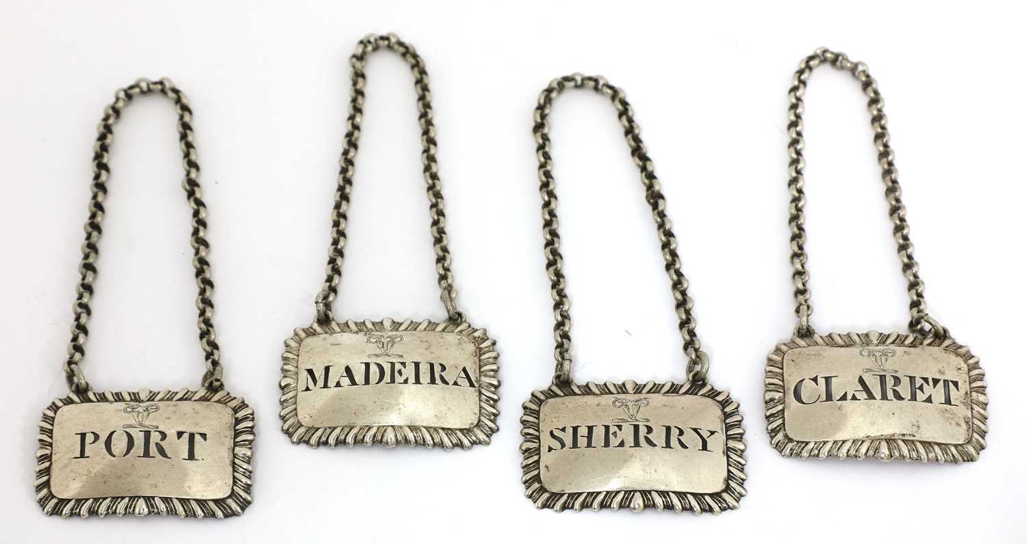 Lot 72 - A set of four George III silver wine labels