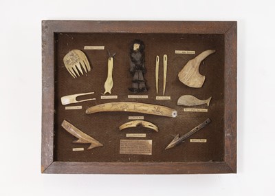 Lot 448 - An oak-framed display of marine ivory, bone and antler 'tools and curios'