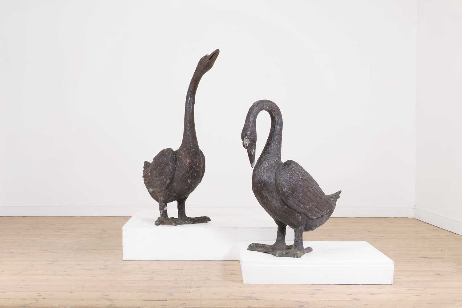 Lot 66 - A pair of patinated bronze geese