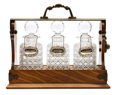 Lot 344 - A walnut, brass and cut-glass three tantalus