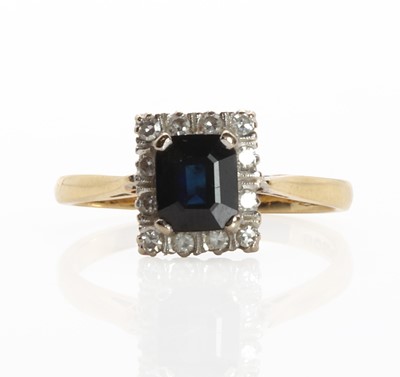 Lot 1155 - An 18ct gold sapphire and diamond cluster ring