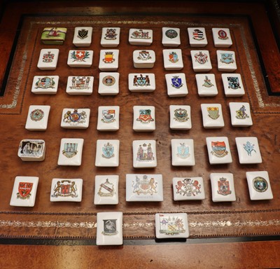 Lot 143 - A large collection of Goss Crested Ware porcelain stamp boxes