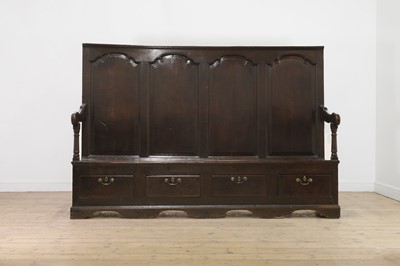 Lot 334 - A carved oak settle