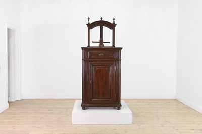 Lot 240 - A provincial oak screw press on a cupboard base