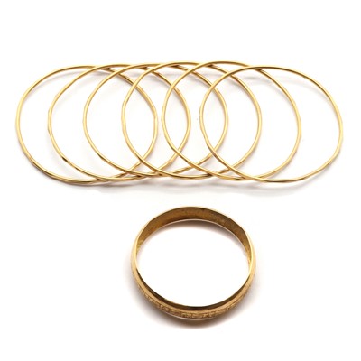 Lot 1303 - A small collection of gold baby bangles