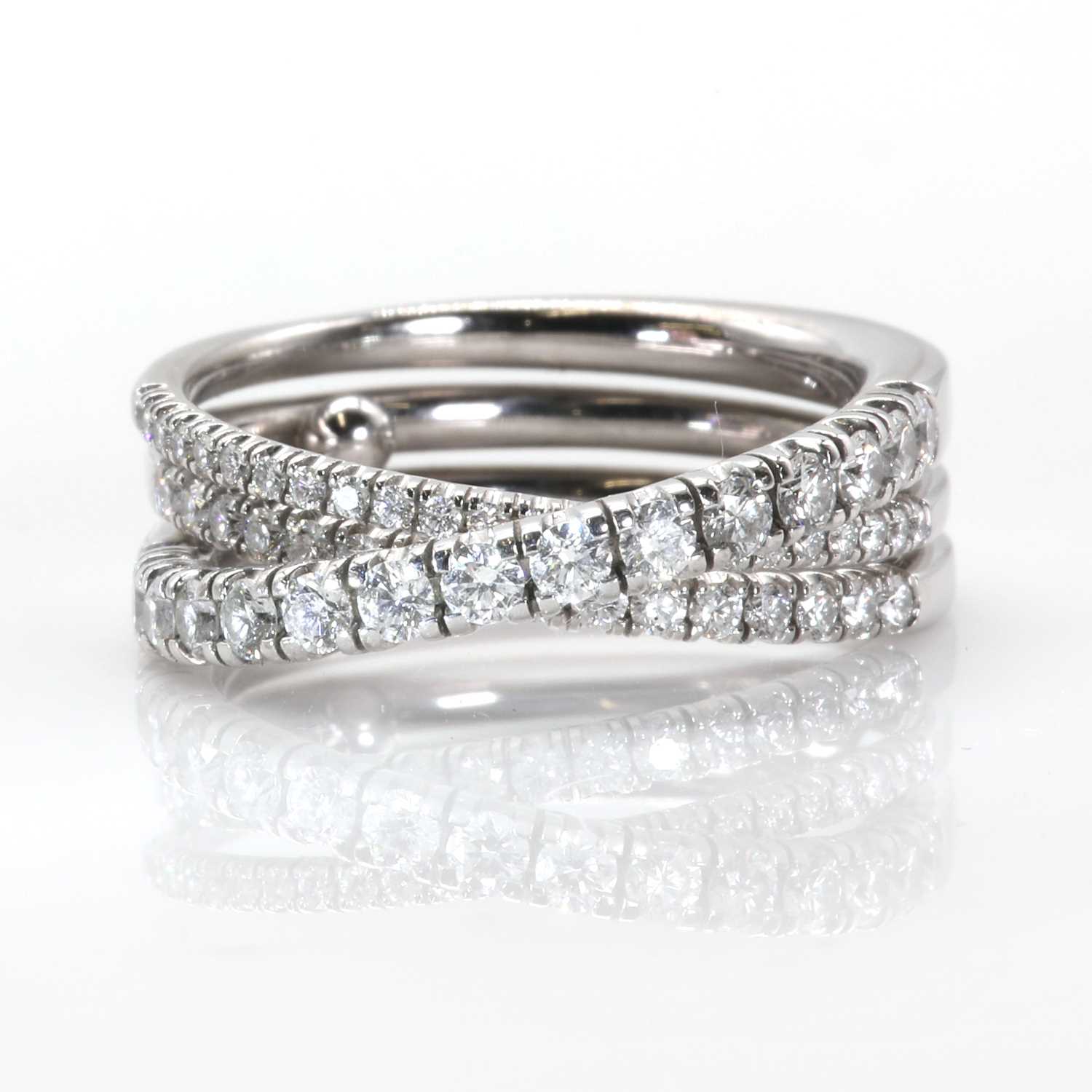 Lot 134 - An 18ct white gold 'Étincelle' three row diamond half eternity ring, by Cartier