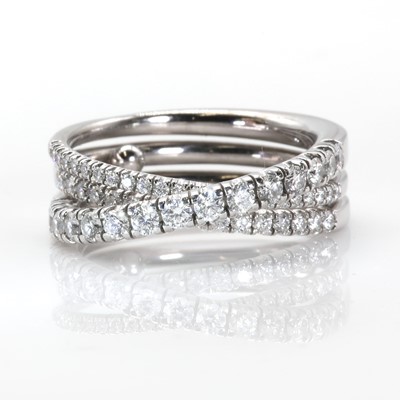 Lot 134 - An 18ct white gold 'Étincelle' three row diamond half eternity ring, by Cartier