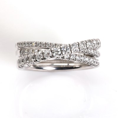 Lot 134 - An 18ct white gold 'Étincelle' three row diamond half eternity ring, by Cartier