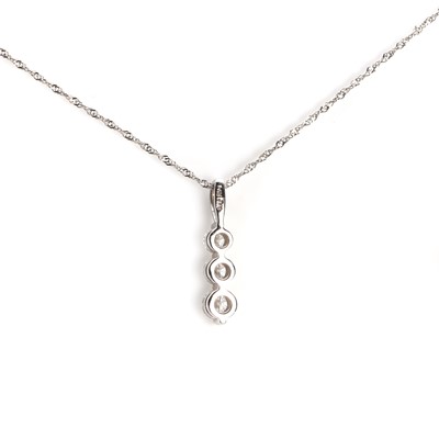 Lot 1060 - A three stone diamond pendant with chain