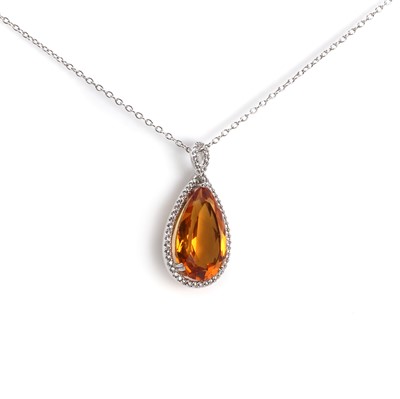 Lot 1141 - A citrine and diamond pendant on chain