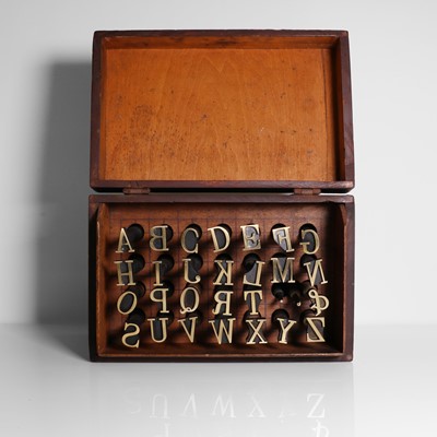 Lot 26 - A set of brass alphabet bookbinder's lettering tools
