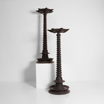 Lot 144 - A pair of bronze oil lamps