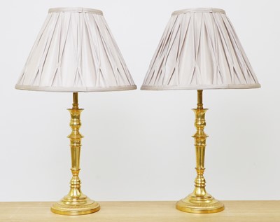 Lot 235 - A pair gilt bronze candlestick lamps