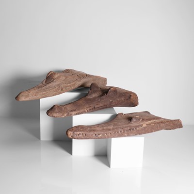 Lot 261 - A group of three carved crocodile boat prows