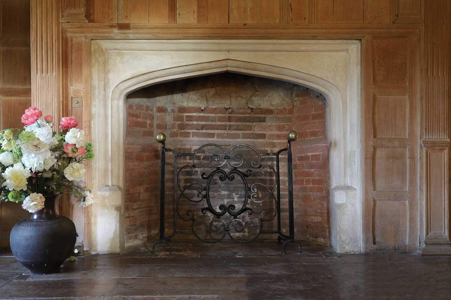 Lot 22 - A cast iron and brass fireguard