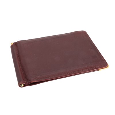 Lot 1463 - A Cartier burgundy leather money clip and two card holder