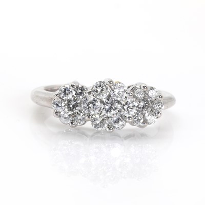 Lot 75 - A white gold diamond set triple floral cluster ring