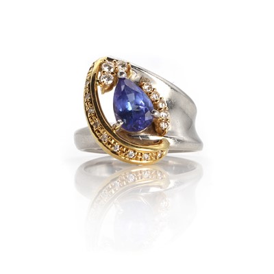 Lot 1169 - A platinum and gold tanzanite and diamond ring